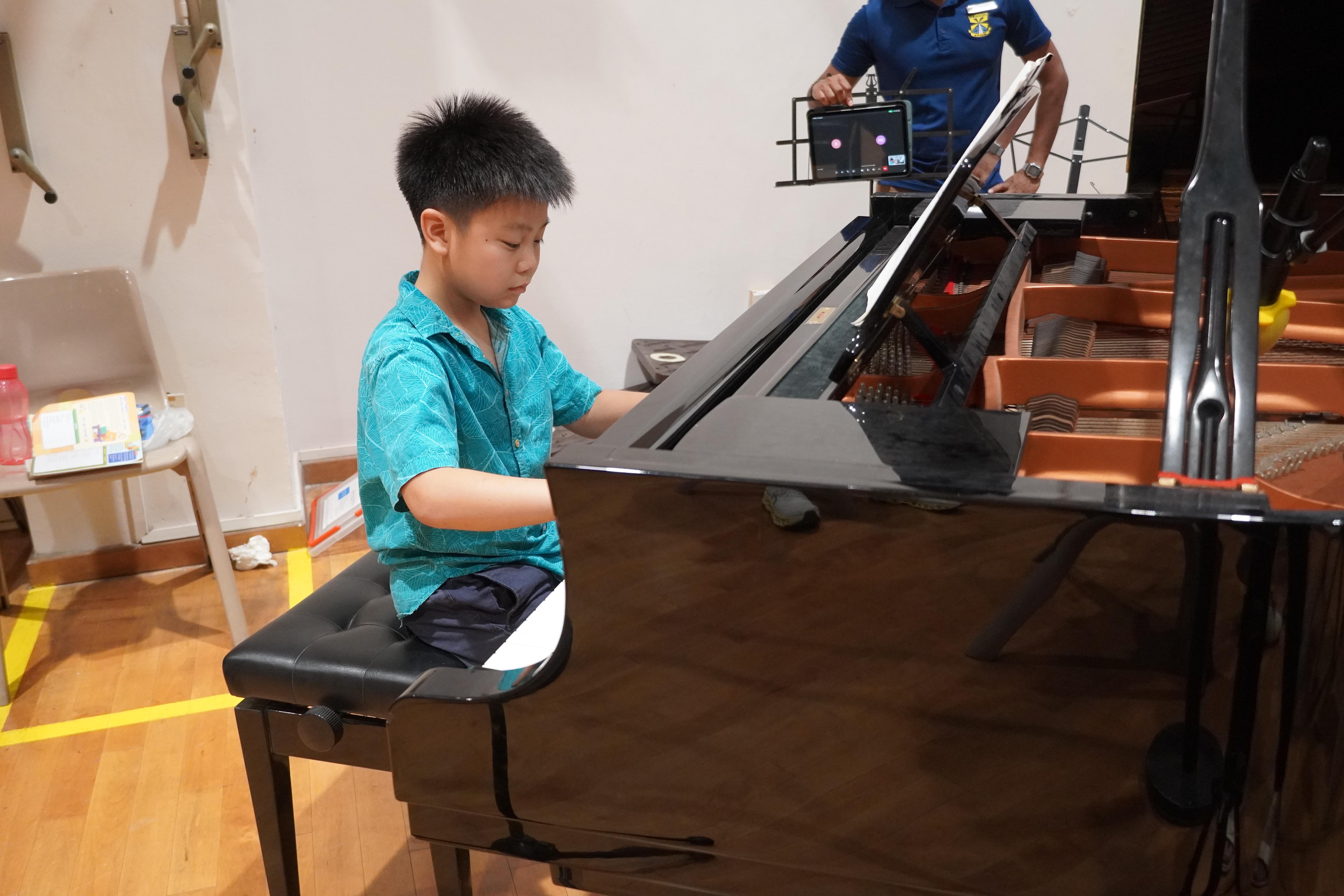 Making music at the keys! Our student impressed the audience as he showcased his musical talent.